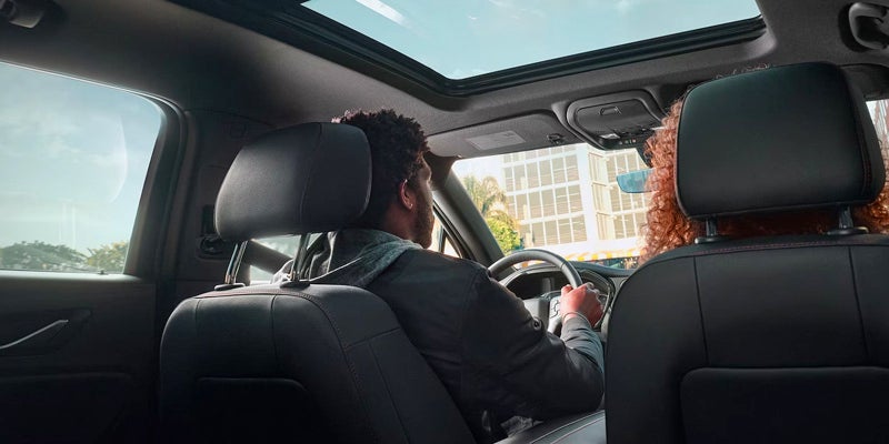 Couple driving a Blazer having stylish sunroof