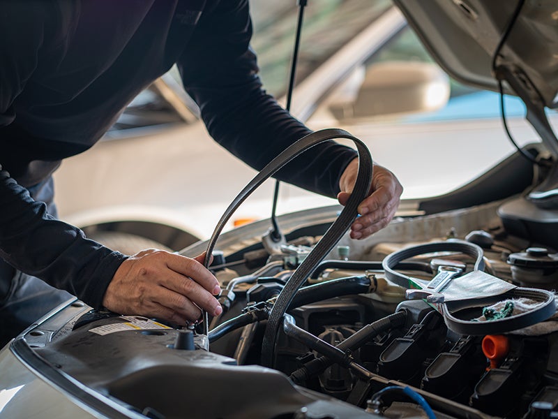 Service technician working on engine